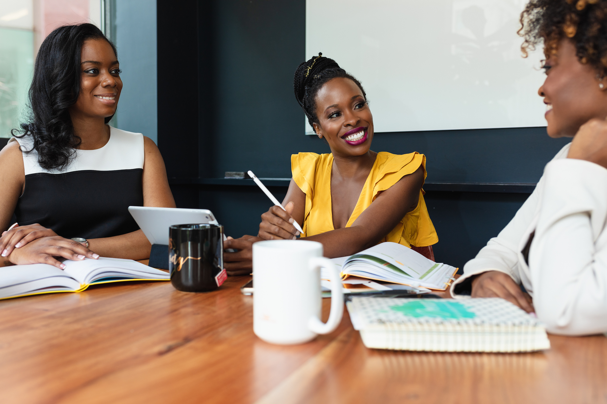 Black businesswomen in leadership meeting Creative Flame Media
